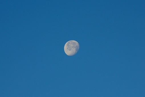 The moon in Malaga in front of the blue sky