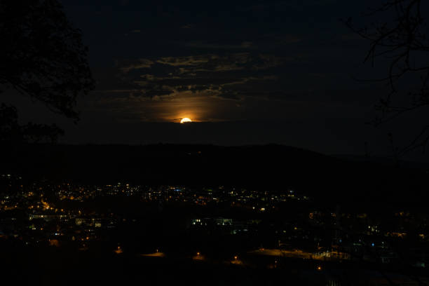 istock Rising super moon over dark city. 1316317612
