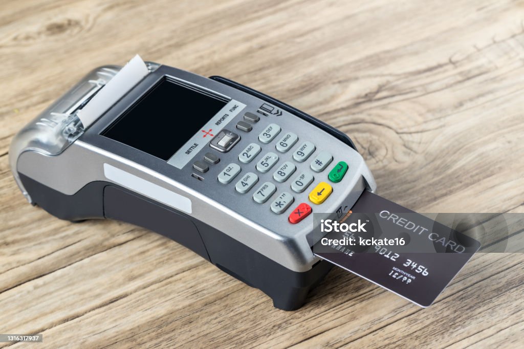credit card swiping machine to pay. credit card swipe through terminal for payment in cafeteria. credit card code in swipe machine. Point Of Sale Stock Photo