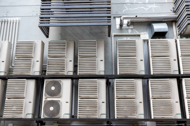 istock Air conditioner compressor installed in old building. Outdoor split wall type air conditioner compressor unit inverter installed on the outside of the building. Air conditioner compressor outdoor unit 1316318019
