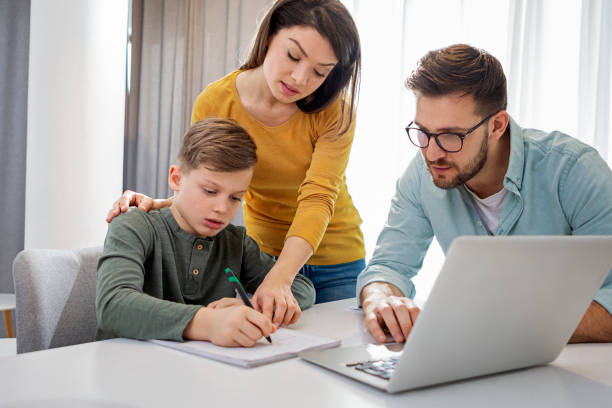 istock Mother and father teaching son and helping with homework 1316318083