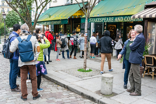 Paris, France - October 1, 2017. Exterior view of Shakespeare and Company bookstore on rue de la Bucherie in Paris, with people lining up in a queue.