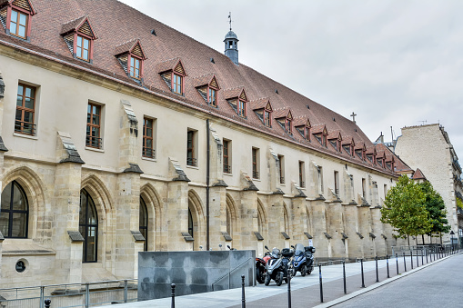 Paris, France - October 2, 2017. The refectory of the College des Bernardins in Paris. Dating back to 1248, this former Cistercian college originally served as living quarters and place of study for novice monks. It is now an arts gallery and centre for Christian culture. Exterior view with motorbikes.