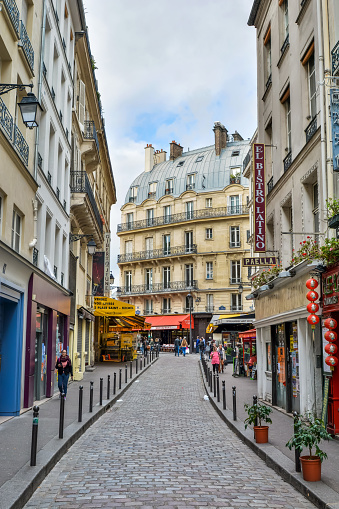 Paris, France - October 2, 2017. Street view on Rue de la Harpe in the Latin Quarter of Paris. View with people, commercial properties and historic buildings.