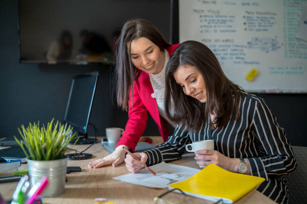istock Young businesswomen talking to each other while being seated in the office at work 1316322430