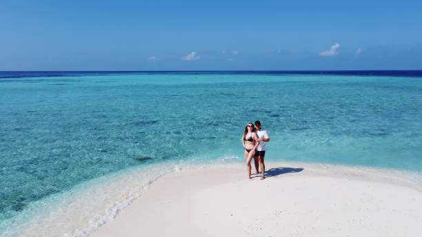 istock Mature couple on vacation hugging on a tropical beach 1316322580