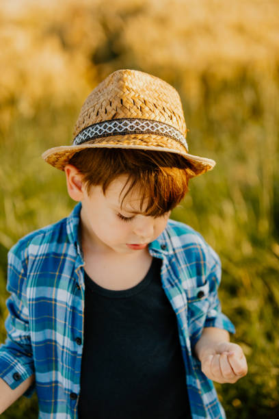 istock Close up of boy standing in farm 1316322724