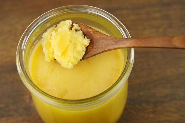 hausgemachte gereinigte butter, ghee (sade yag) in glas und holzlöffel. - butter dairy product fat food stock-fotos und bilder