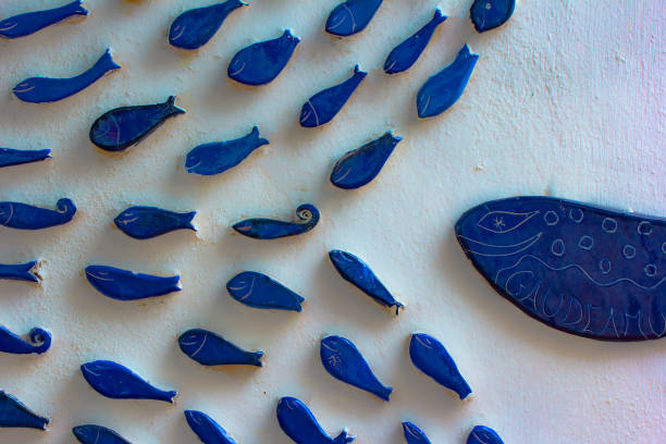 pottery on the wall. small fish chased by big fish