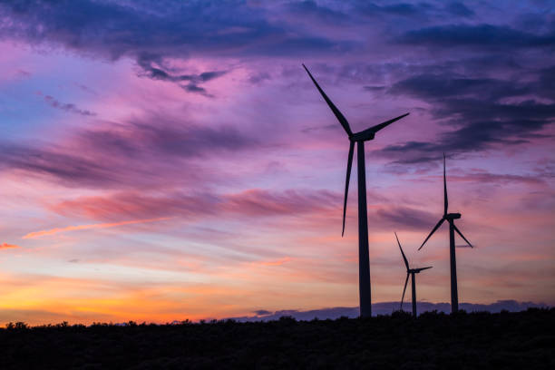 Triple wind turbine sunset clouds at Wild Horse Wind Farm Triple wind turbine sunset clouds at Wild Horse Wind Farm kittitas county windmill sunset stock pictures, royalty-free photos & images
