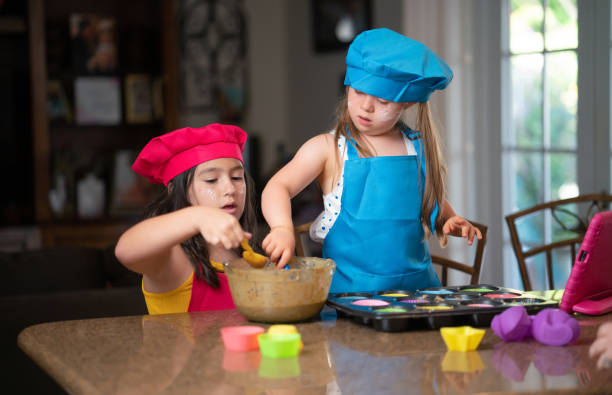 istock Two friends following a cupcake recipe online 1316330292