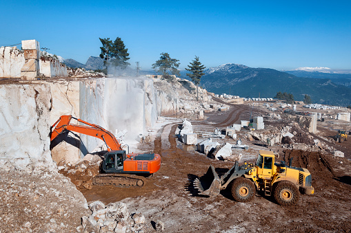 Marble mining with heavy machinery. Stock Photo
