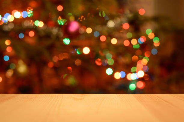 istock Christmas holiday background with empty wooden desk table over decorated christmas tree 1316333898