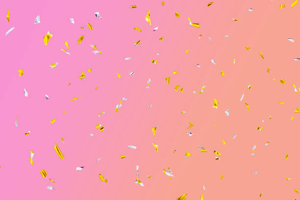 istock Golden silver sparkling fly confetti on pink-orange background. Holiday effect 1316333906