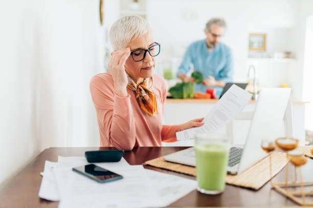 istock Senior woman calculating bills 1316334072