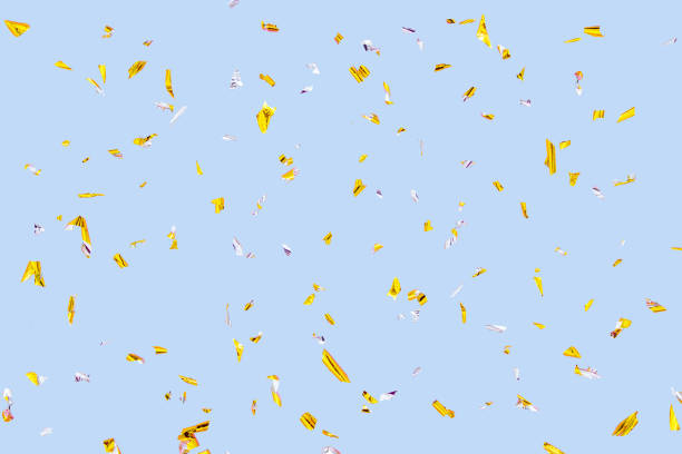 istock Golden silver sparkling confetti isolated on blue. Holiday effect 1316334084