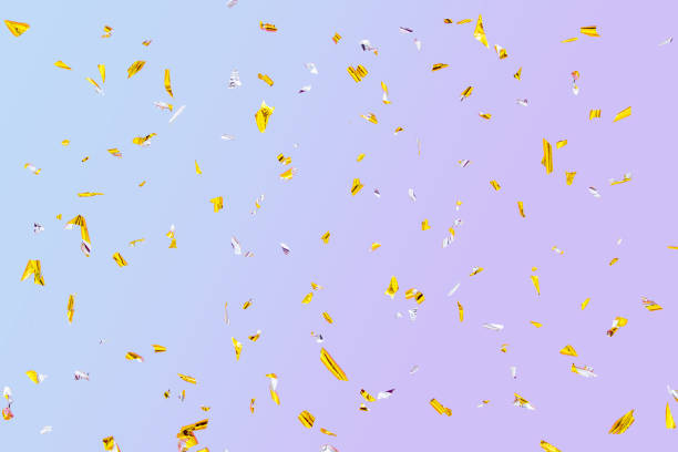 istock Golden silver sparkling fly confetti on blue-purple background. Holiday effect 1316334183