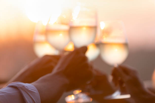 istock Group of friends having fun and toasting outdoors with white wine. 1316334235
