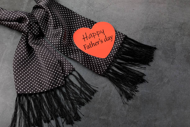 istock Happy Father's Day concept. Black men's scarf with white dots. 1316335192