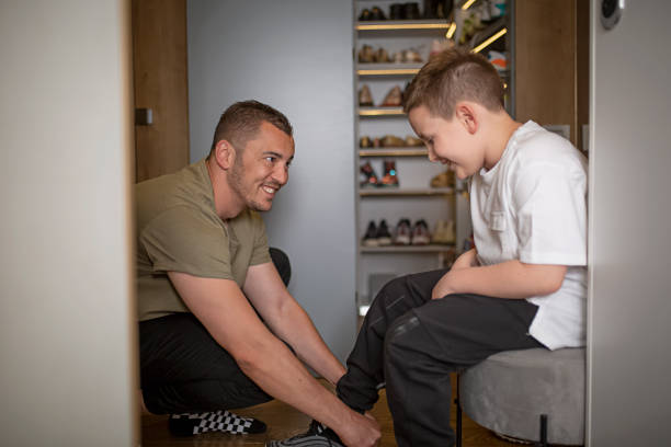 istock Father teaching his son how to tie a sports shoe 1316337767