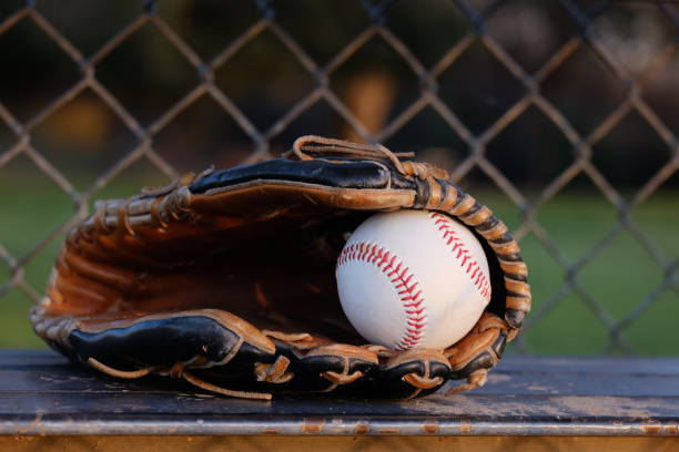 istock Baseball glove and ball in dugout 1316338444