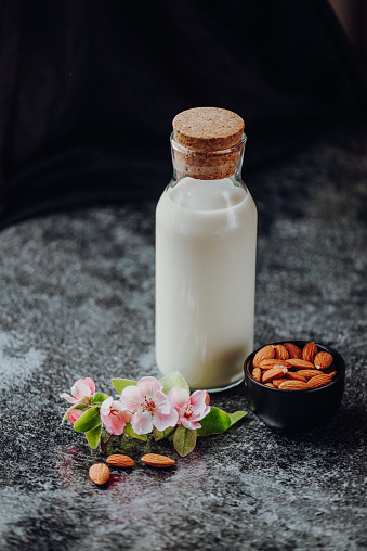 Beautiful Shot of Almond Milk with Flowers from the Almond Tree and Almonds in Spring 2021, California, USA