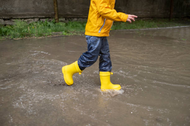 istock Adorable little boy playing at rainy day 1316339422