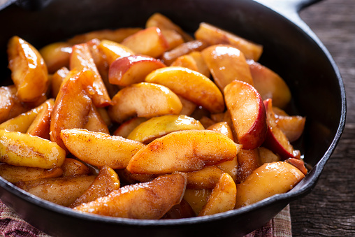 Fall baking. Autumn baking concept. Ingredients for baking - flour, sugar, apples and spices. Top view at white wooden table.