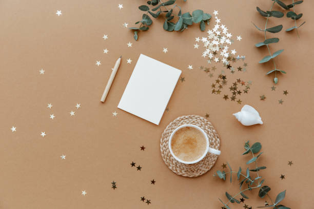 istock Flat lay coffee cup and blank card over brown background. Top view, copy space. Blogger or magazine concept 1316344338