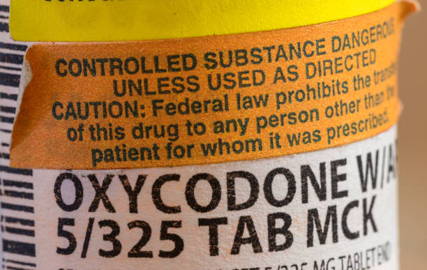 Oxycodone opioid tablets bottle and label in extreme close up for court battle in WV stock photo