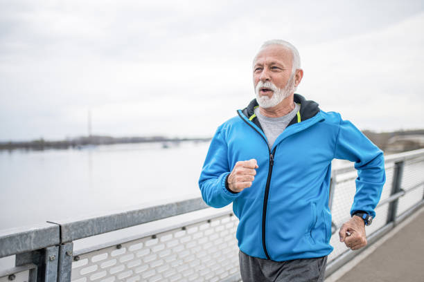 istock Senior sportsman running outdoors on a bridge. 1316347292
