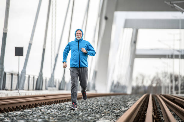 istock Senior sportsman running outdoors on a bridge. 1316347294