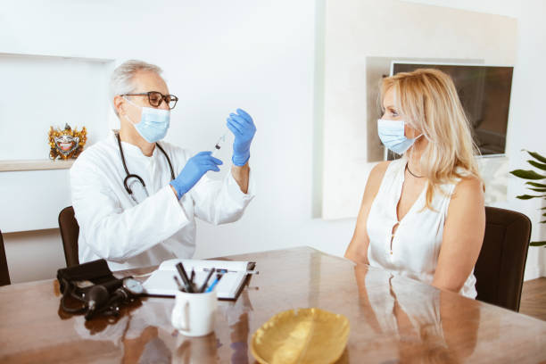 istock Doctor vaccinates woman in a doctor's office 1316349654