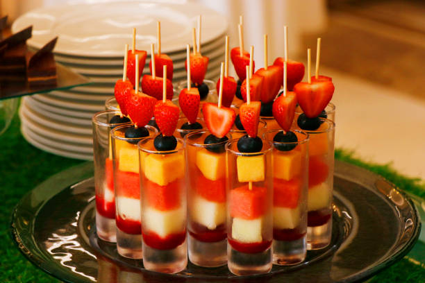 assorted fresh fruits on a skewer in a glass