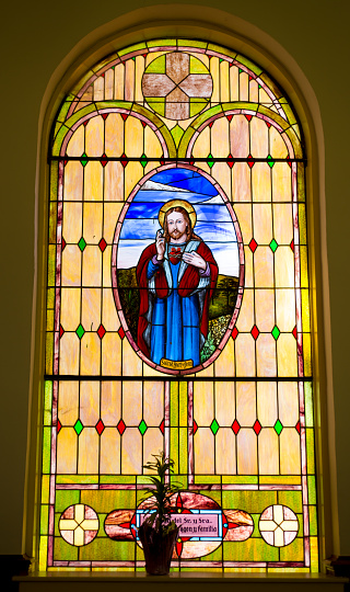 Background image of ethereal church interior in all white with stained glass window at altar