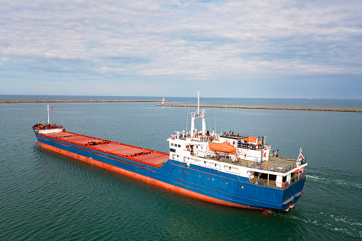 High angle view of single big cargo ship on sea over sunny blue sky