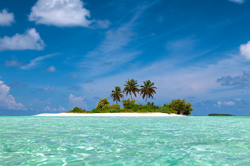 A little tropical island in Maldives with a turqouise lagoon and nobody on the photograph.