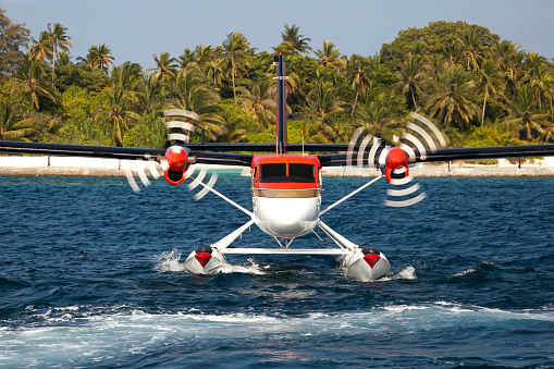 Seaplane take off from a resort lagoon front image