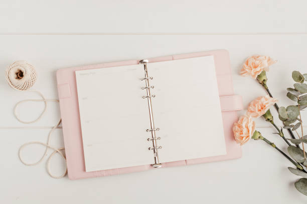 istock Open planner and flowers. Workspace with notebook. Freelance business, organization, wedding planning 1316370137