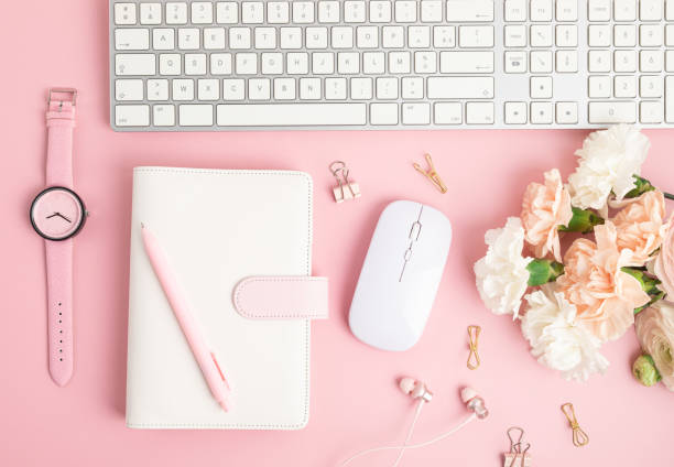 Home office desktop and flowers. Modern workspace with notebook, office stationary