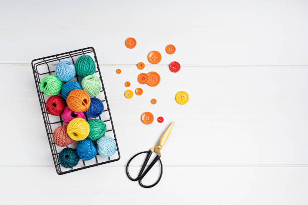 Diy, hobby, handwork concept. Tools and accessories for crafting and leisure. Sissors, bobins of threads and buttons