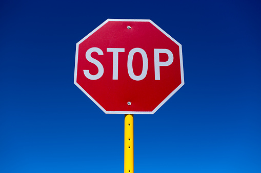 STOP Sign, Vibrant Blue Background