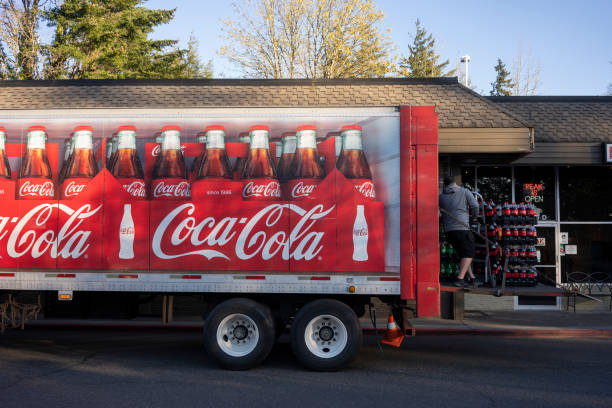 Coca-Cola Delivery Driver Lake Oswego, OR, USA - Apr 12, 2021: A Coca-Cola delivery driver unloads his truck outside of a Domino's Pizza restaurant in Lake Oswego, Oregon. coca cola stock pictures, royalty-free photos & images