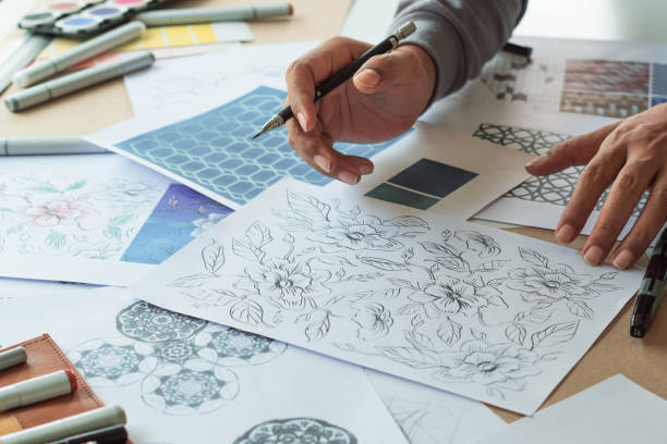 istock Designer designing drawing sketch pattern geometric flower seamless wallpaper fabric textile fashion industry. artistic design studio. 1316374220