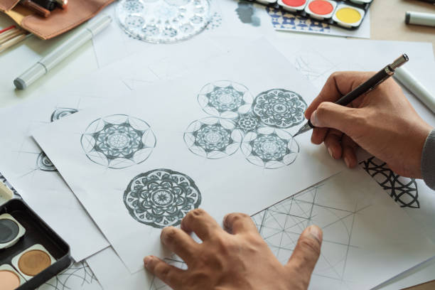 istock Designer designing drawing sketch pattern geometric flower seamless wallpaper fabric textile fashion industry. artistic design studio. 1316374226