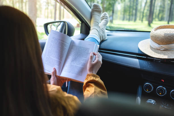 istock A woman reading book while riding the car 1316381928