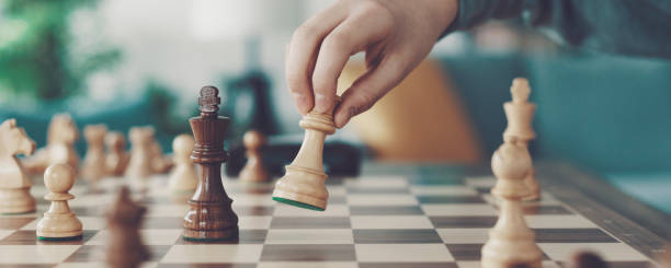 istock Boy playing chess and moving a piece 1316385931