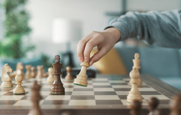 istock Boy playing chess and moving a piece 1316387037
