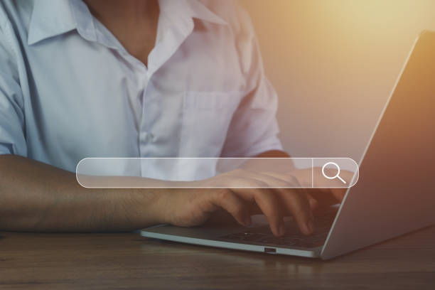 istock Hand businessman using laptop at home office workplace. Blank search bar webpage with browser of Internet data background. Searching on web search SEO engine network concept. Business technology . 1316388832