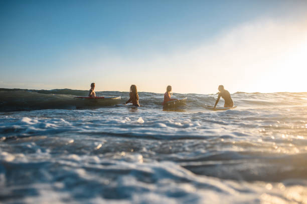 istock Four Gold Coast Surfers Standing in Water with Boards 1316390035